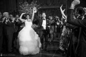 A bride and groom waving to the crowd at their summer wedding at Cipriani 42nd Street.