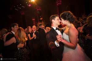 A couple joyfully shares their first dance at a summer wedding held at Cipriani 42nd Street.