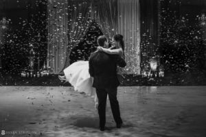 Wedding photo of a bride and groom dancing in confetti at the Crystal Tea Room.