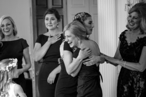 Black and white photo of bridesmaids hugging each other at a wedding in Union Trust in Philadelphia.