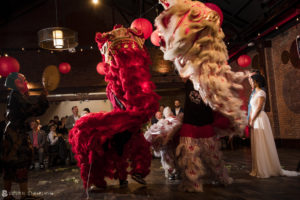 Chinese lion dancers perform at a wedding at 26 Bridge.