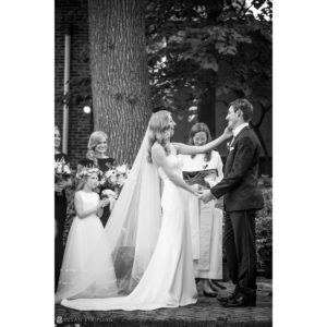 A black and white photo capturing the heartfelt vows exchanged by a bride and groom at their wedding at Union Trust in Philadelphia.