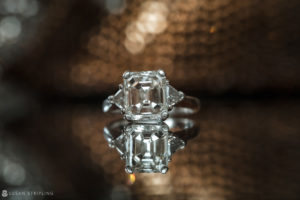 A stunning engagement ring featuring an emerald cut diamond, perfect for a wedding at Flowerfield Celebrations.