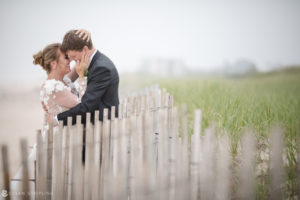Description: A bride and groom kiss at a wedding at the Bridgehampton Tennis and Surf Club.