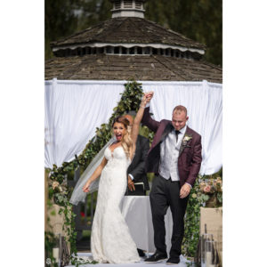 A bride and groom joyfully walk down the aisle at their splendid wedding at Flowerfield Celebrations.