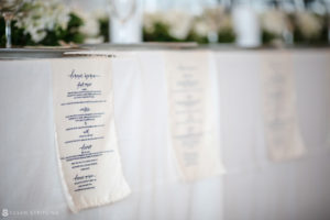 A white tablecloth with a wedding menu on it at the Bridgehampton Tennis and Surf Club.