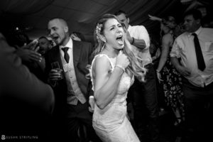 A bride is dancing on the dance floor at a flowerfield wedding celebration.
