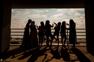 A group of women are silhouetted on a balcony overlooking the ocean at Ocean Place Resort.
