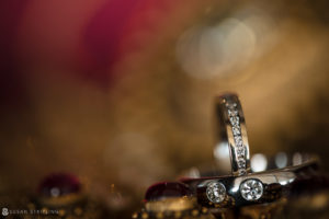 A pair of Spa Wedding rings on a table with a blurred background at Ocean Place Resort.