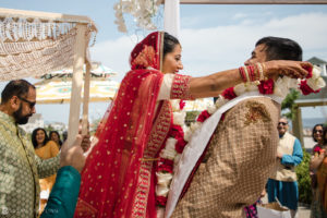 A bride and groom are having a traditional Indian wedding ceremony at Ocean Place Resort.