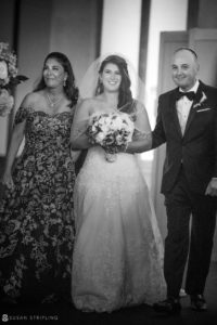 A bride and groom walking down the aisle during their beautiful wedding at Pier Sixty.