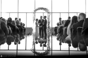 A black and white photo of a wedding ceremony at Loews Hotel in Philadelphia.