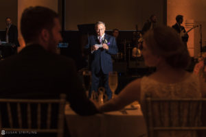 A man giving a speech at a Philadelphia wedding reception in Loews Hotel.