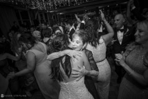 A woman hugging her mother on the dance floor at a wedding at Pier Sixty.