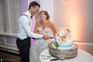 A bride and groom cutting their wedding cake at the Wedding at the Berkeley Oceanfront Hotel.