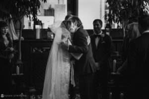 A summer wedding at the Gramercy Park Hotel, where a bride and groom share a kiss during their ceremony.