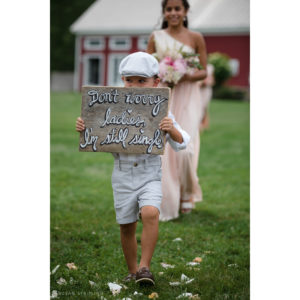 A little boy holding a wedding sign at Riverside Farm.