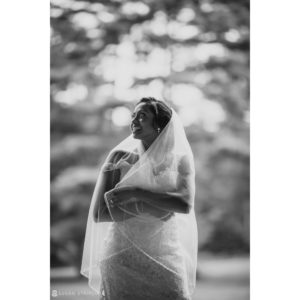 A summer wedding at Riverside Farm, with a bride wearing a black and white veil.