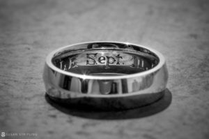 A silver ring with the word september on it, perfect for a wedding.