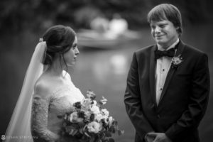 A Central Park elopement captured in a black and white photo, showcasing the intimate moment between a bride and groom as they gaze lovingly at each other.