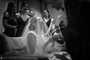 A black and white wedding photo capturing a bride and groom kissing at the Westin in Philadelphia.
