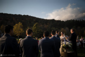 A fall wedding at Riverside Farm nestled in the mountains, where a radiant bride and groom exchange vows amidst nature's breathtaking beauty.