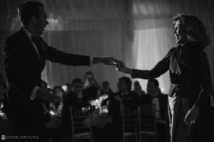 A man and woman gracefully dancing at a wedding reception held at Sleepy Hollow Country Club.