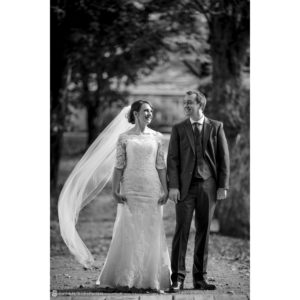 A black and white wedding photo of a bride and groom at Riverside Farm.