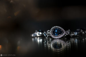 A stunning engagement ring adorned with blue sapphires and diamonds, perfect for a romantic park chateau wedding.