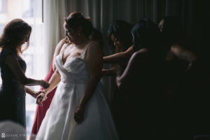 A bride getting ready for her wedding with her bridesmaids at 501 Union.