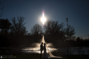 A wedding couple standing in front of the Park Chateau fountain.