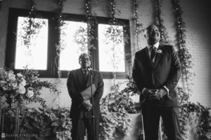 A man in a suit standing in front of a window at 501 Union.