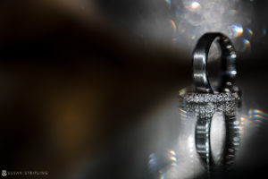 A black wedding ring on a shiny surface at Park Chateau.