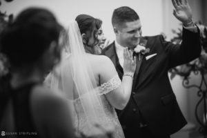 A bride and groom waving at each other during their Wedding ceremony at Park Chateau.