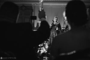A black and white photo of a woman singing at a wedding at Park Chateau.
