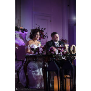 A bride and groom sitting at a Park Chateau wedding table.