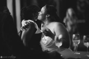 A woman kisses another woman at a wedding reception at 501 Union.