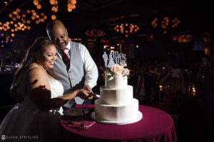 A wedding couple cutting their cake at 501 Union.