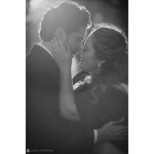 A black and white photo of a bride and groom sharing an intimate moment at their Manhattan wedding in a private club.