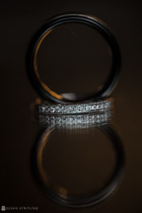 A Wedding Ring is reflected on a Quantum Leap Winery black surface.