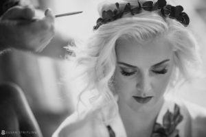 A bride getting her hair done at Quantum Leap Winery in a black and white photo.