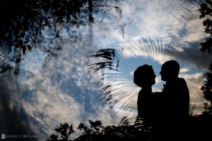 A wedding couple silhouetted against the sky at Quantum Leap Winery.