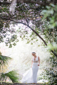A bride in a white dress walking through the Quantum Leap Winery.