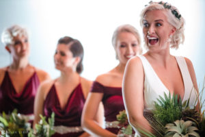 A bride laughing with her bridesmaids at a Quantum Leap Winery wedding.