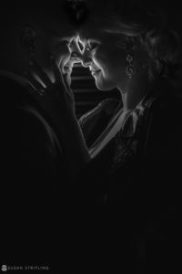 A black and white photo of a couple embracing in the dark at their wedding at Quantum Leap Winery.