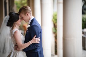 A bride and groom embracing in the courtyard of the Alfond Inn during their wedding ceremony.