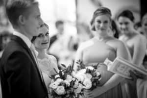 A bride and groom exchange heartfelt glances during their Alfond Inn wedding ceremony.