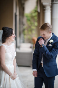 A wedding couple laughing at each other in the beautiful courtyard of Alfond Inn.