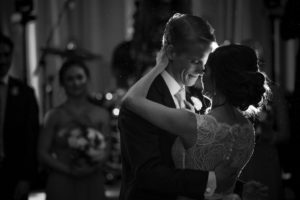 A wedding at the Alfond Inn featuring a bride and groom sharing their first dance in black and white.