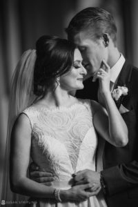 At the beautiful Alfond Inn, a wedding couple joyfully embrace each other in black and white.